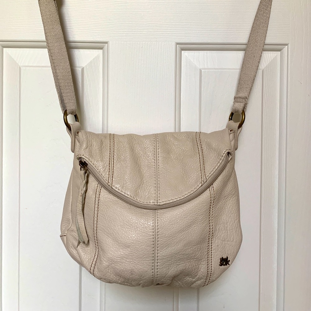 The Sak cream colored cross body bag